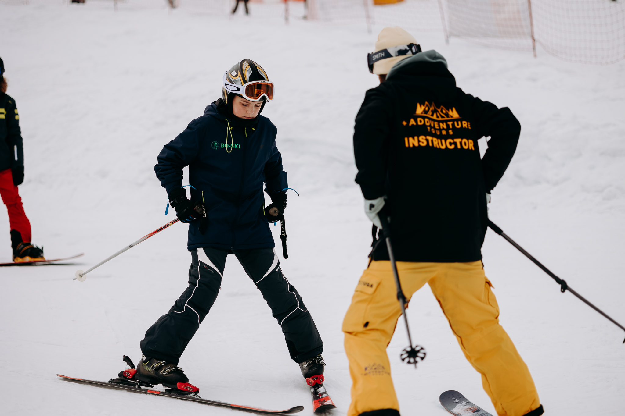 Ski instructor teaching a beginner 